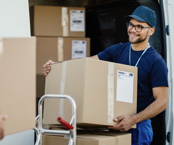 Summit County mover loading and unloading furniture and boxes into a residential home.