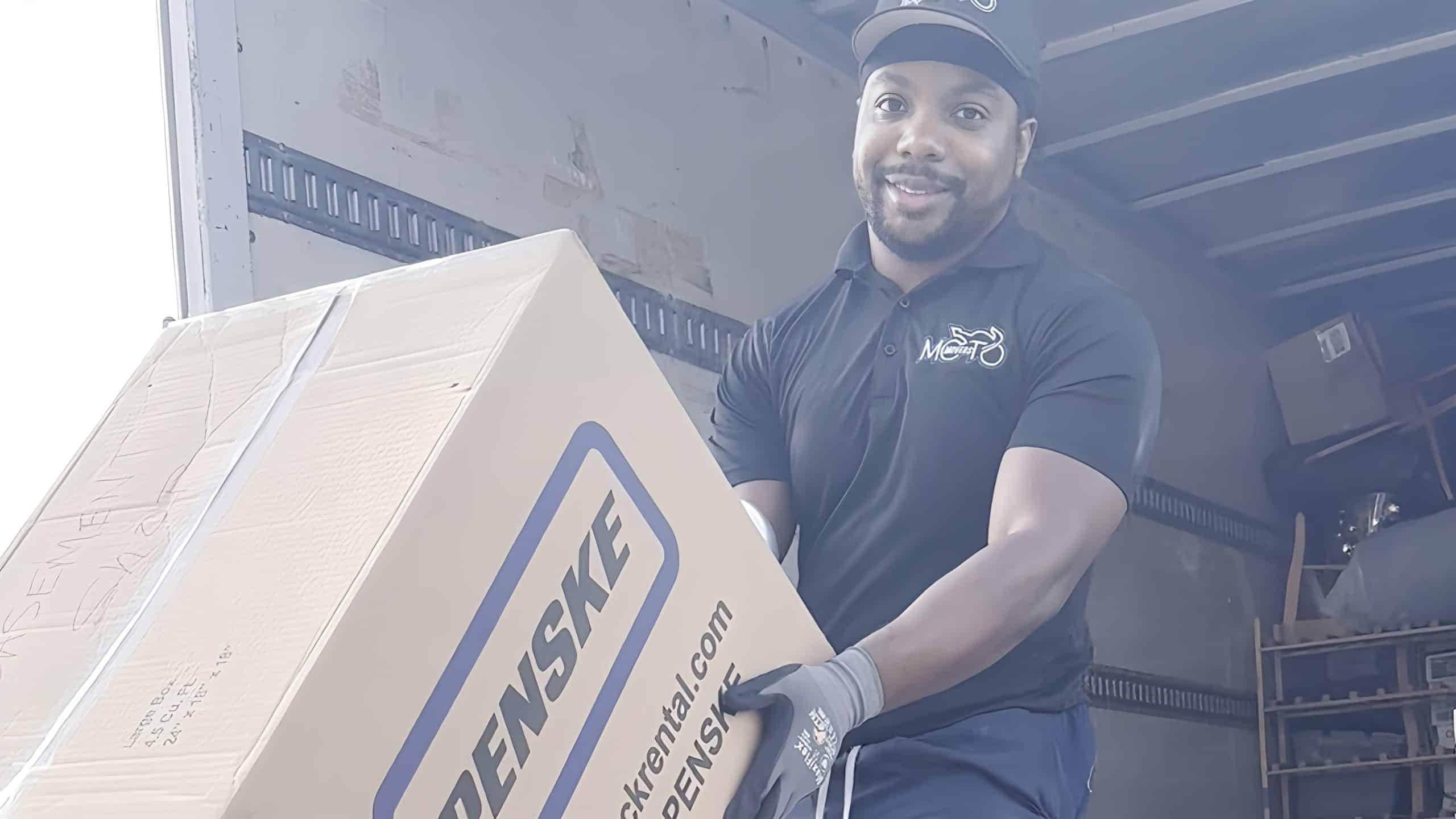 a man moving boxes into a truck