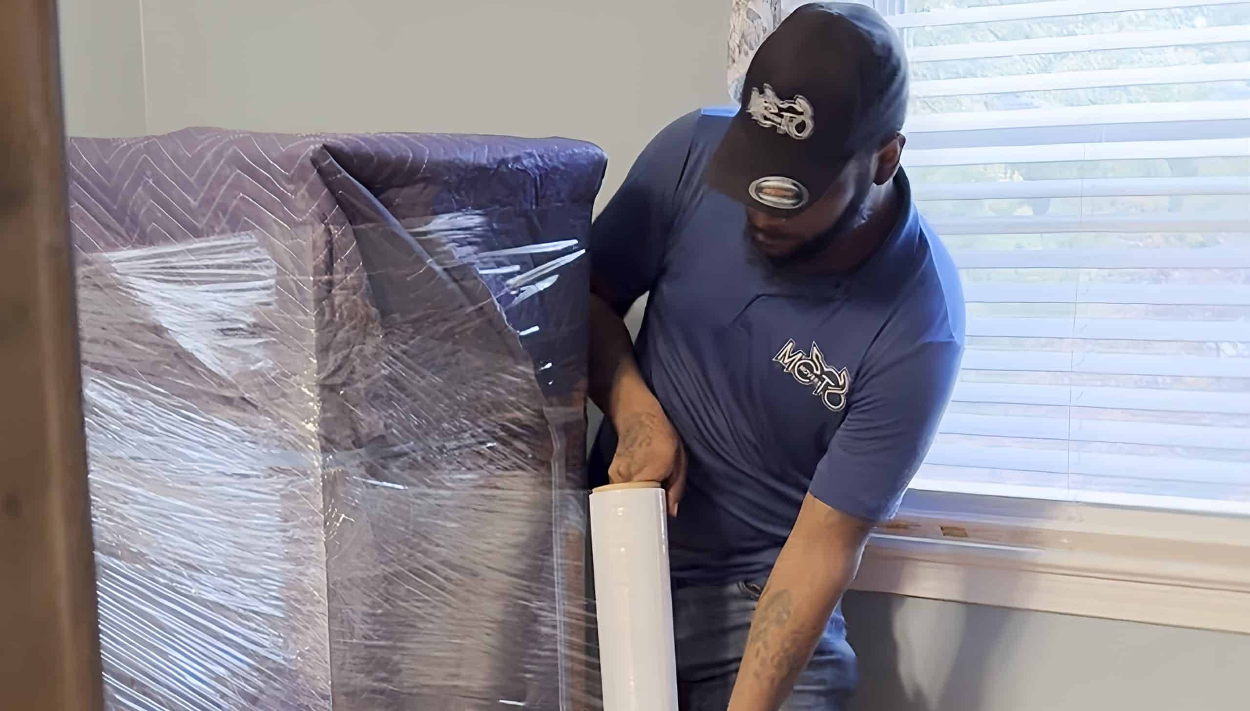 A man wrapping furniture